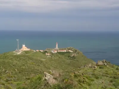 a lighthouse on top of a hill with the ocean at Chambre d'hotes CHEVREFEUILLE in Molitg les Bains