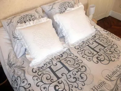 a bed with two pillows on top of it at La Maison d'hôtes du Chapelier in Espéraza