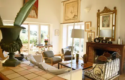 a living room with a couch and a fireplace at Les Oliviers in Cesseras