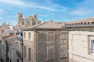 a view of a cathedral from the roofs of buildings at Central Narbonne with rooftop terrace in Narbonne