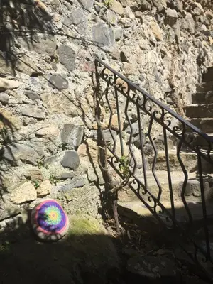 a frisbee on the ground next to a stone wall at les galets de l agly, 6 ch, 12 couchages Semaine ou WE famille amis copains in Le Vivier