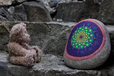 a teddy bear sitting next to a rock at les galets de l agly, 6 ch, 12 couchages Semaine ou WE famille amis copains in Le Vivier