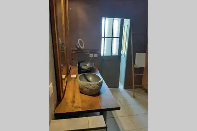 a room with a bowl on a wooden table at Loft atelier dans ancien domaine viticole in Moux