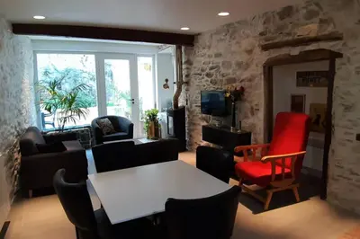 a living room with a white table and chairs at Havre de paix au pied de la montagne in Les Ilhes