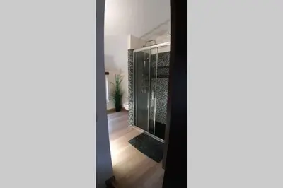 a bathroom with a glass shower in a room at Havre de paix au pied de la montagne in Les Ilhes