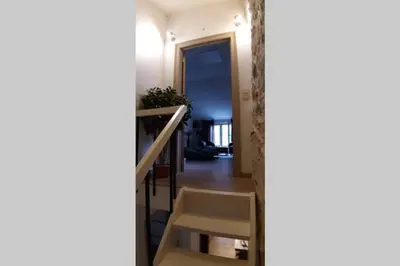 a stairway leading to a hallway with a stair case at Havre de paix au pied de la montagne in Les Ilhes