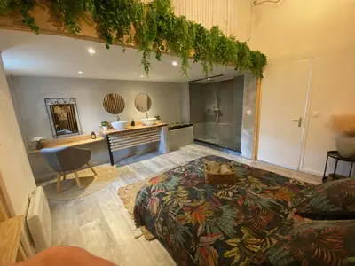a bedroom with a bed and a desk in a room at le joyau de la cite in Carcassonne