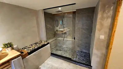 a bathroom with a shower with a tub and a sink at le joyau de la cite in Carcassonne