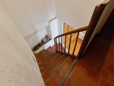 a stairway with a wooden railing and a stair case at Charming Holiday Home in Tautavel with Balcony in Tautavel