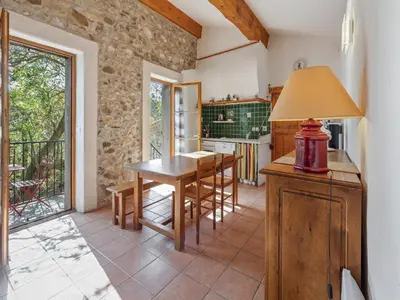 a kitchen with a table and chairs in a room at Charming Holiday Home in Tautavel with Balcony in Tautavel