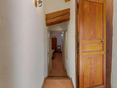 an empty hallway with a wooden door in a room at Charming Holiday Home in Tautavel with Balcony in Tautavel