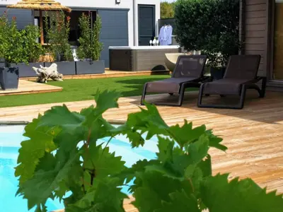 a backyard with two chairs and a swimming pool at Suite l'inattendu avec Spa privatif et espace bien-être. in Moussan