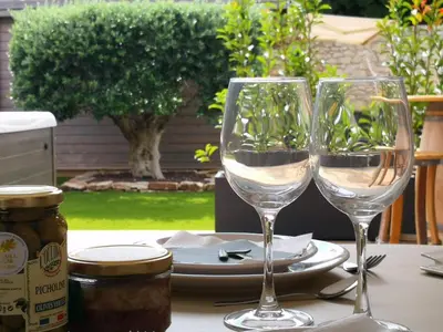 two wine glasses sitting on top of a table at Suite l'inattendu avec Spa privatif et espace bien-être. in Moussan