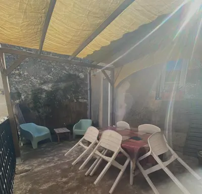a room with a table and chairs in a tent at la Porte bleue in Capestang