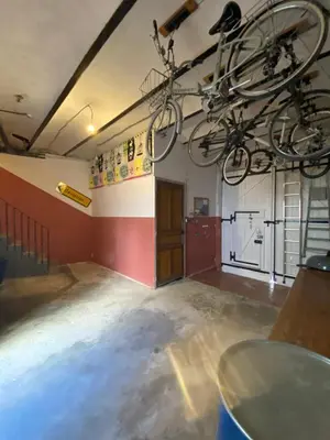 an empty room with a bike hanging from the ceiling at la Porte bleue in Capestang