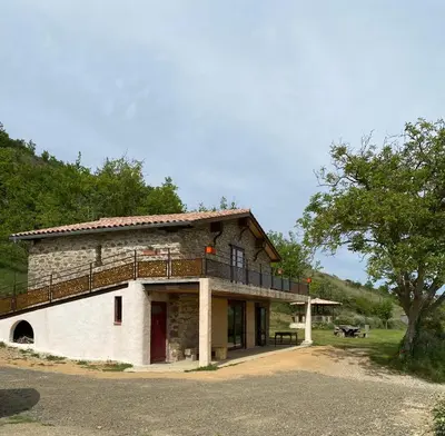 a building with a balcony on top of it at La Grange du Soleil in Rouvenac