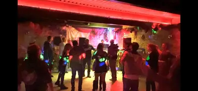 a group of people standing in front of a nightclub at La Grange du Soleil in Rouvenac