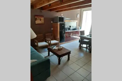 a living room with a couch and a table at Cave atelier dans ancien domaine viticole in Moux