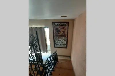 a room with a staircase with a picture on the wall at Cave atelier dans ancien domaine viticole in Moux