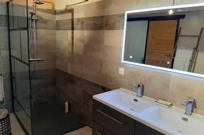 a bathroom with a sink and a shower at Cave atelier dans ancien domaine viticole in Moux
