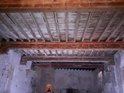 an old building with a wooden ceiling in a room at MAISON DIANA in Capestang