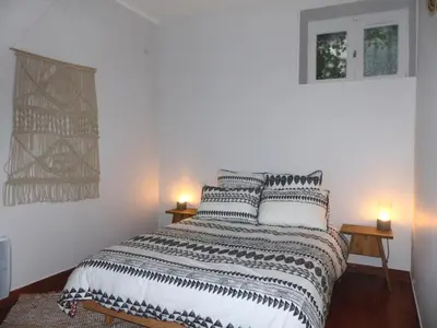 a bedroom with a bed with two lamps on it at Le tout cosy - Wifi - Disney - EvasionPamiers in Pamiers
