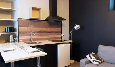 a kitchen with a sink and a desk with a lamp at Le tout cosy - Wifi - Disney - EvasionPamiers in Pamiers