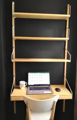 a laptop computer sitting on a desk with shelves at Le tout cosy - Wifi - Disney - EvasionPamiers in Pamiers