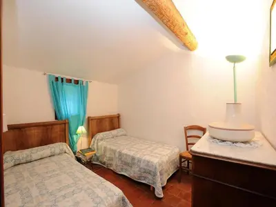 a bedroom with two beds and a table and chairs at Holiday Home in Tautavel near Gorges de Gouleyrous in Tautavel