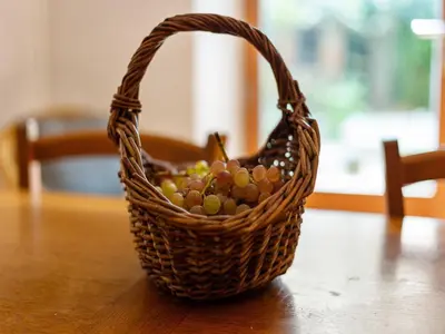 a basket of grapes sitting on top of a table at Holiday Home in Tautavel near Gorges de Gouleyrous in Tautavel