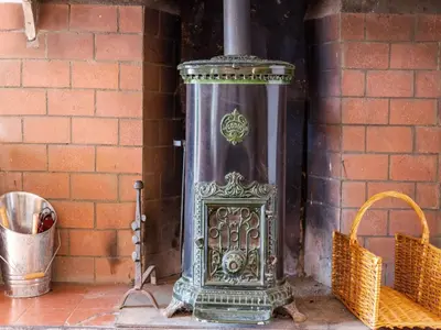 a metal object sitting next to a brick wall at Holiday Home in Tautavel near Gorges de Gouleyrous in Tautavel
