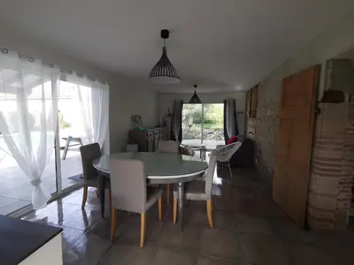 a kitchen with a refrigerator and a window at Le pigeonnier de La Mouline in Viterbe