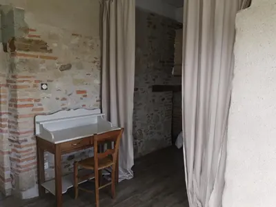 a living room with a couch and a table at Le pigeonnier de La Mouline in Viterbe