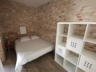a kitchen with white cabinets and a large window at Le pigeonnier de La Mouline in Viterbe