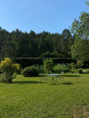 two chairs and a table in the middle of a field at Le Parc - Suite climatisée in Magrie
