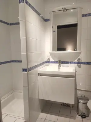 a white bathroom with a sink and a mirror at Les chambres de la Caussade in Lautrec