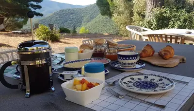 a table with plates of food on top of it at Gites-Terroirs-Occitanie in Felluns