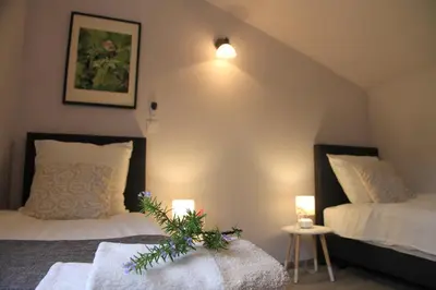 a bedroom with two beds and two lights on the wall at Gites-Terroirs-Occitanie in Felluns