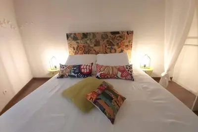 a large white bed with two pillows on it at Le 68b in Carcassonne