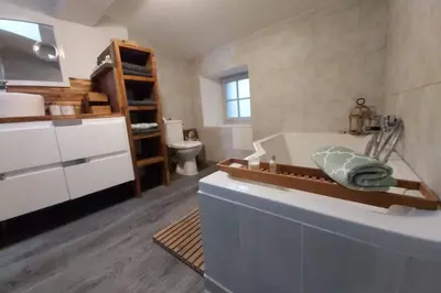 a bathroom with a tub and a sink and a toilet at Le 68b in Carcassonne