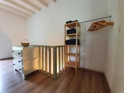 a room with a staircase and a desk and a closet at Gîte confortable avec SPA privé et confort moderne in Pont-de-Larn