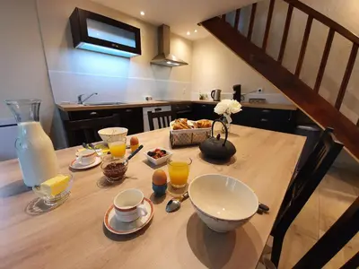 a table with a bowl of food and drinks on it at Gîte confortable avec SPA privé et confort moderne in Pont-de-Larn