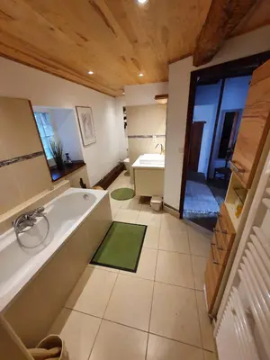 a large bathroom with a tub and a sink at L'Ancienne Forge in Villarzel-du-Razès