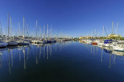 a bunch of boats are docked in a harbor at Les Ilots de Gruissan in Gruissan
