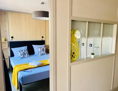 a bedroom with a bed with blue sheets and pillows at Les Ilots de Gruissan in Gruissan