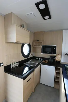 a small kitchen with a sink and a microwave at Les Ilots de Gruissan in Gruissan