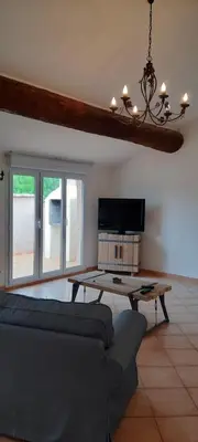 a living room with a couch and a table at Le Coq du Nord - Mailhac Gîte et Chambres d'Hôtes in Mailhac