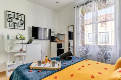 a bedroom with a bed with a tray on it at Le bourget - Suite romantique in Narbonne