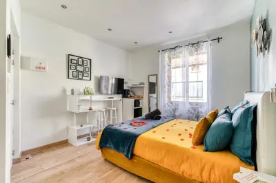 a bedroom with a large bed and a window at Le bourget - Suite romantique in Narbonne