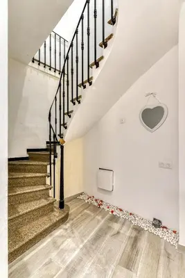 a staircase in a white building with a stair case at Le bourget - Suite romantique in Narbonne